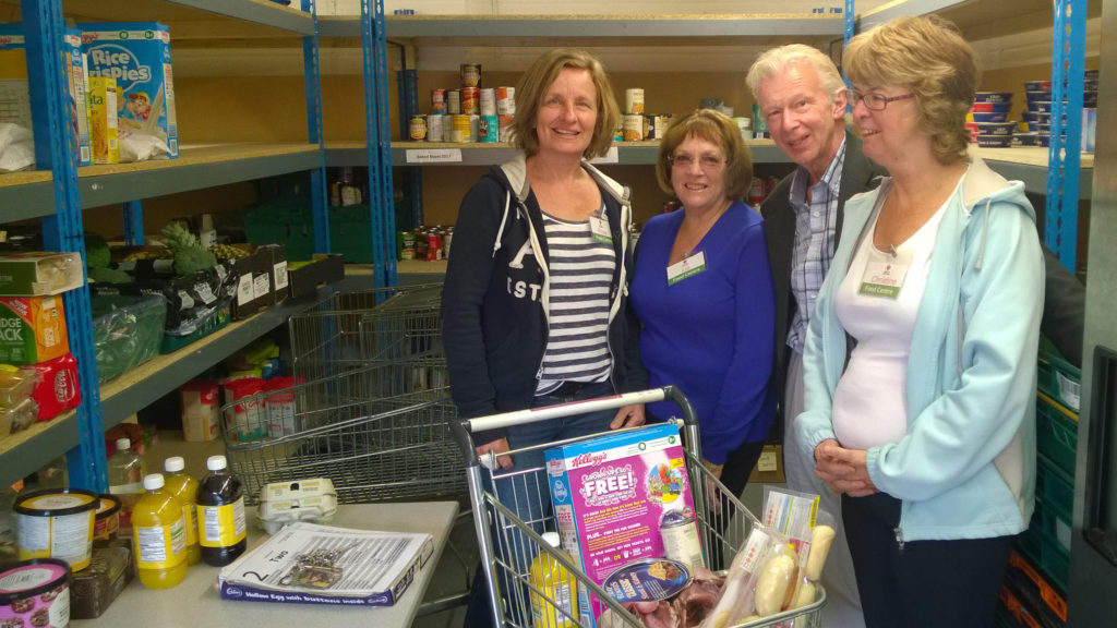 Volunteers at the Hedge End Food Centre, telling Bruce about their work